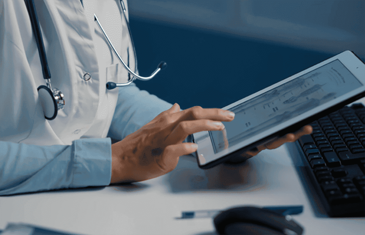 Clinician reviewing patient records on a tablet