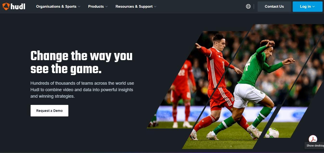 Hudl homepage headlined "Change the way you see the game", showing two soccer players contesting the ball