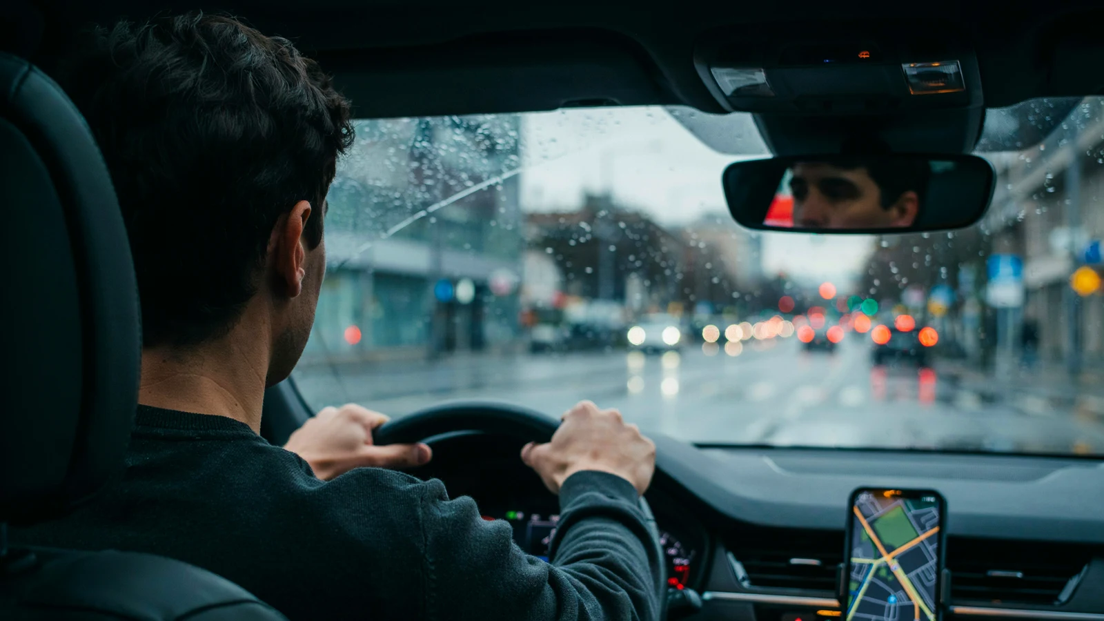 Driver's view of dusk traffic with a navigation route on the dashboard, one of many AI applications in real life