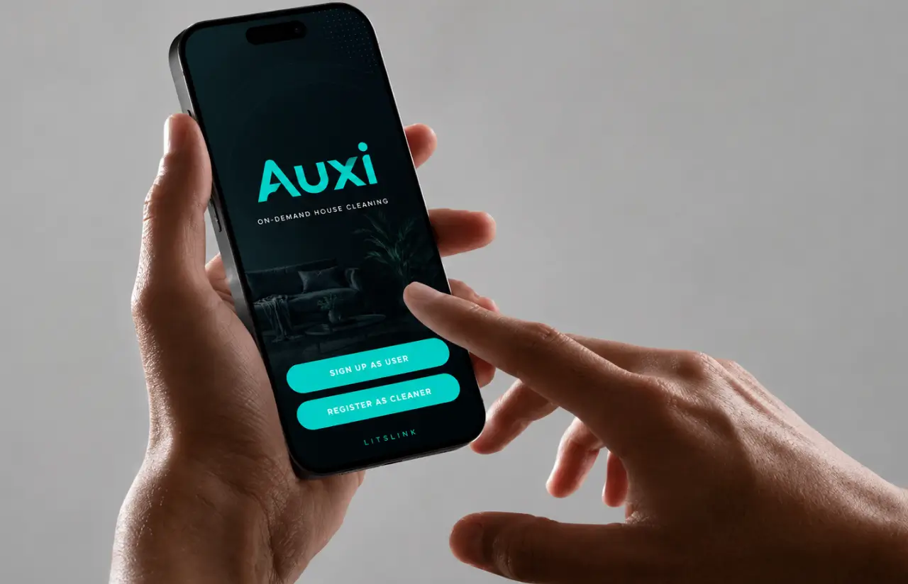 Hand holding a phone with the Auxi on-demand house cleaning splash screen and two buttons: sign up as user, register as cleaner