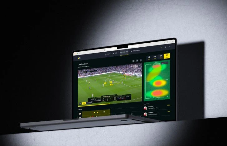 Laptop showing a live football match prediction dashboard with a player movement heatmap