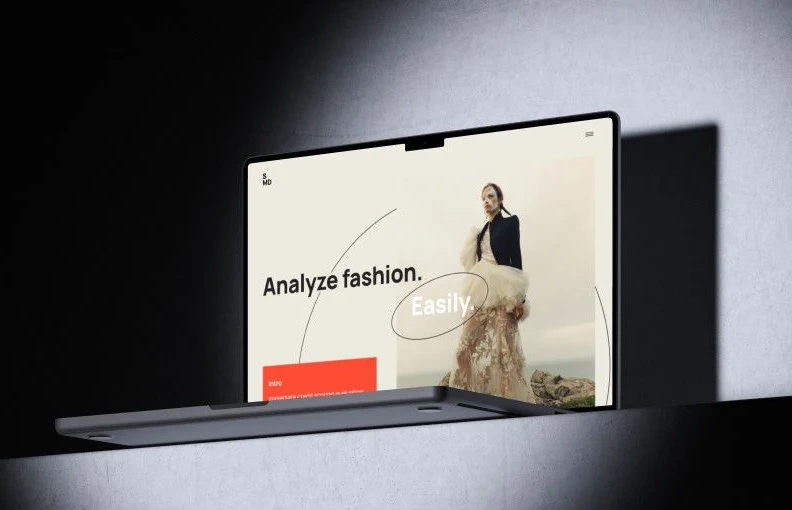 Laptop showing a fashion analysis web app hero screen reading Analyze fashion. Easily.