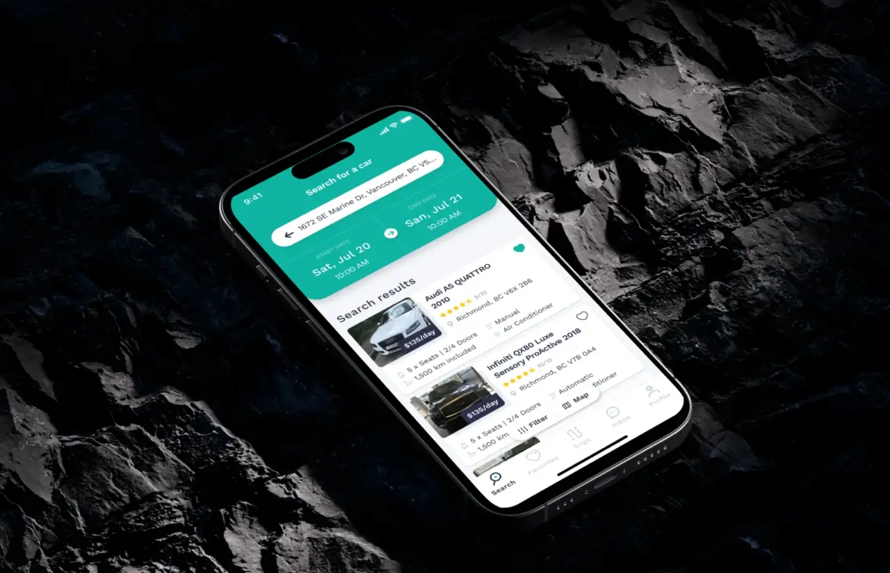 Phone on a dark rock surface showing a car search for pickup and return dates, with results listing cars, ratings, seats, mileage and daily price