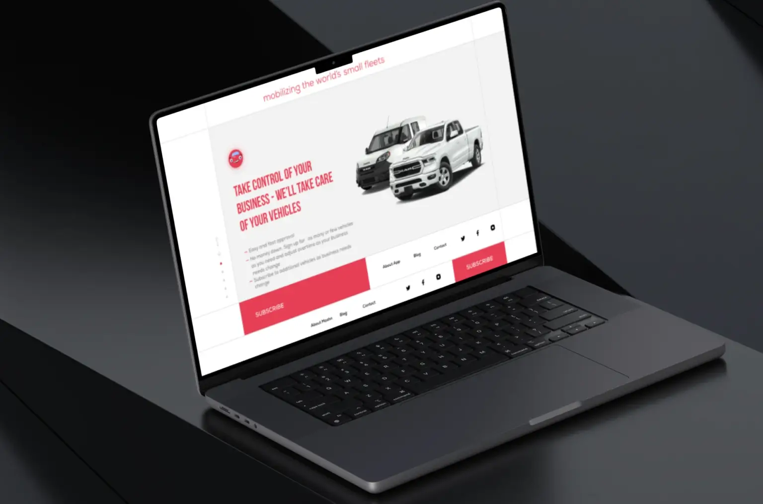 Laptop on a dark desk showing a vehicle subscription landing page with a van and a pickup truck and a subscribe button