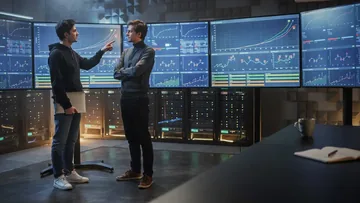 Machine learning operations team checking CI/CD pipeline status and model performance in a server room