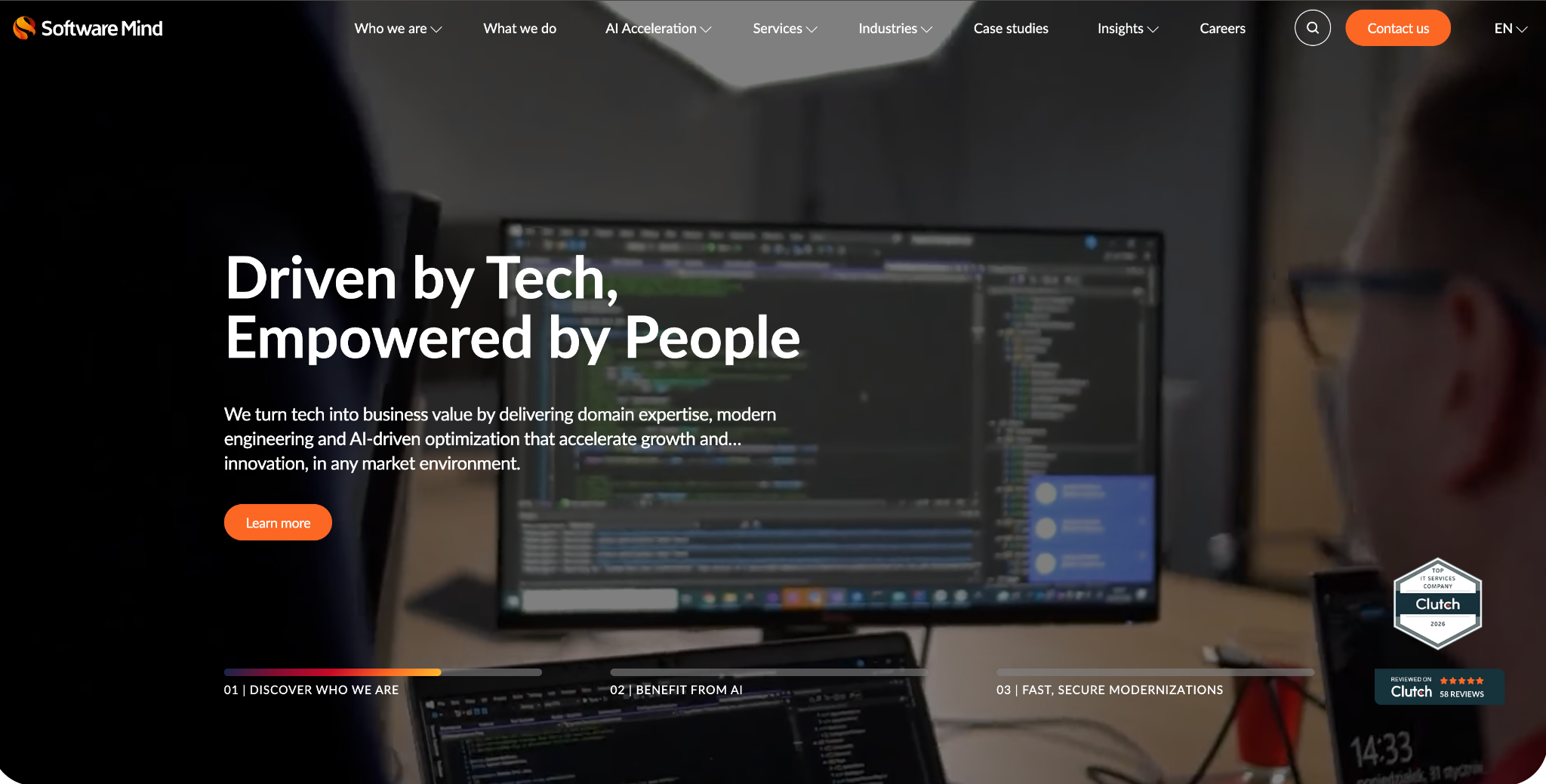 Software Mind homepage hero: "Driven by Tech, Empowered by People" over a developer at a code-filled monitor, with Clutch top IT services badges.