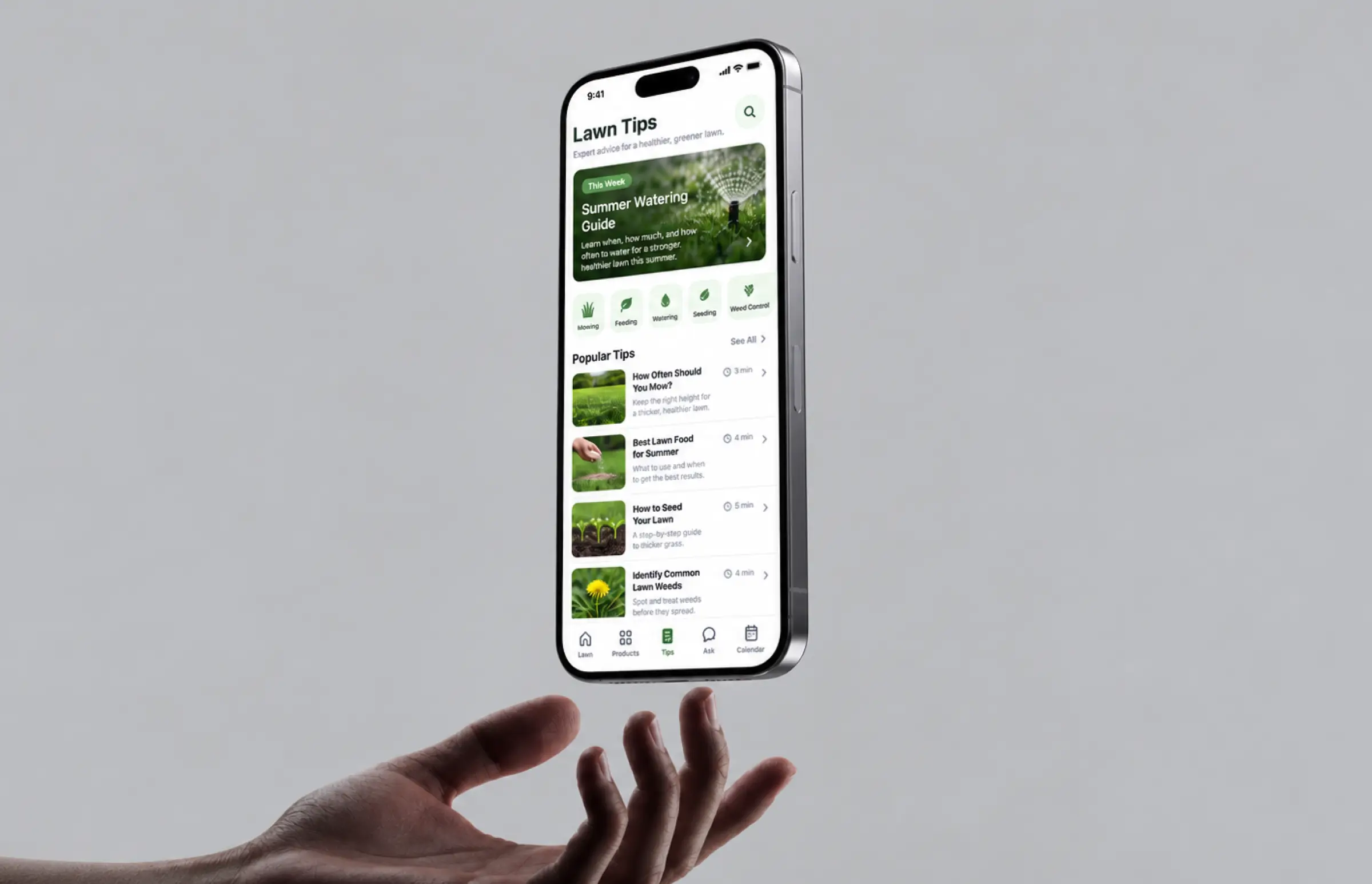 Phone screen with a summer watering guide at the top and a list of popular lawn tips: mowing height, best lawn food for summer, how to seed, identifying common weeds