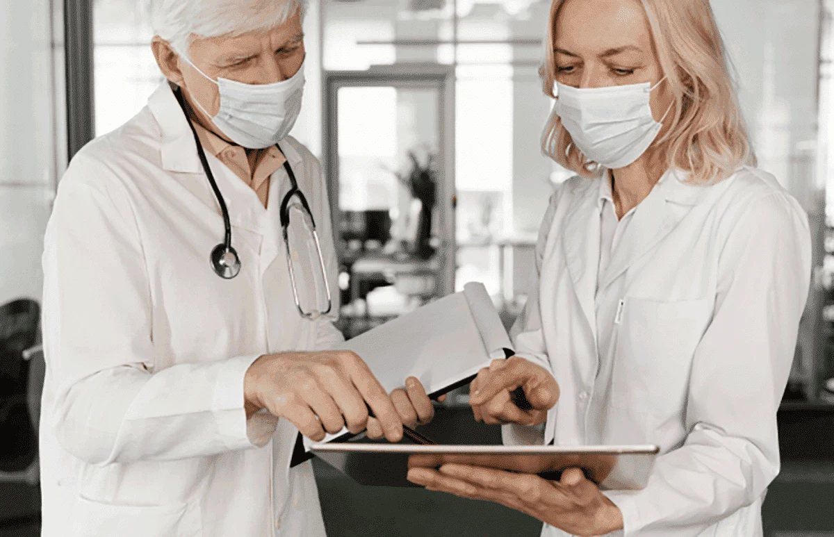 Doctors reviewing shifts on a tablet