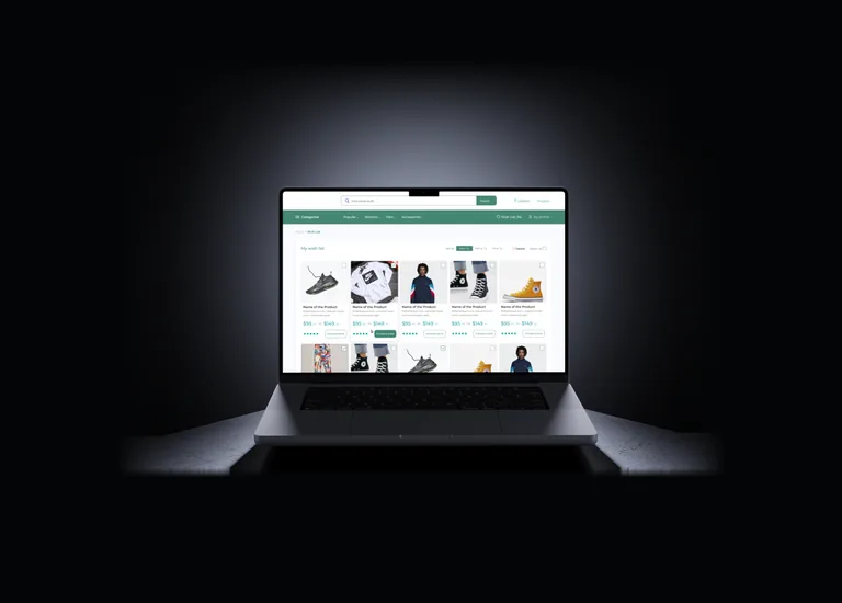 Laptop on a dark surface showing the Online Shop wish list — a grid of saved products with star ratings, price ranges and Compare price buttons, under the shop's search bar and category navigation.