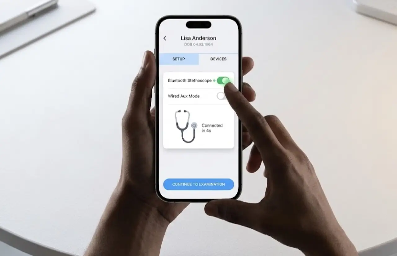 A phone held in two hands showing the device setup screen: a Bluetooth stethoscope toggle switched on and a wired aux mode toggle off, with the stethoscope shown as connected in four seconds and a continue to examination button