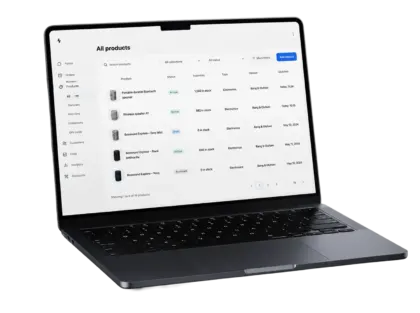 Laptop showing the merchant product catalog with generated descriptions listed against each SKU